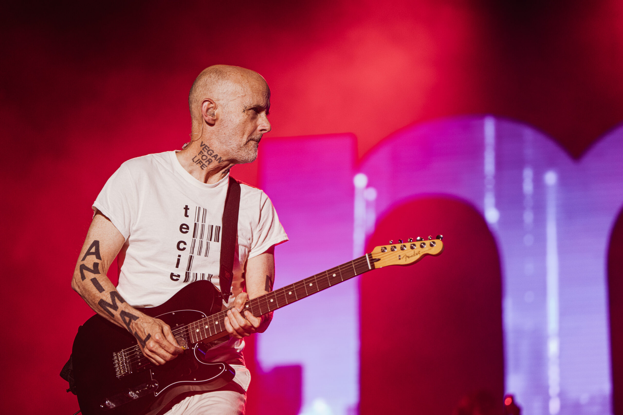 Moby performing guitar during his live show with large-scale visual projections behind him at Release Athens Festival, Athens, 2026.