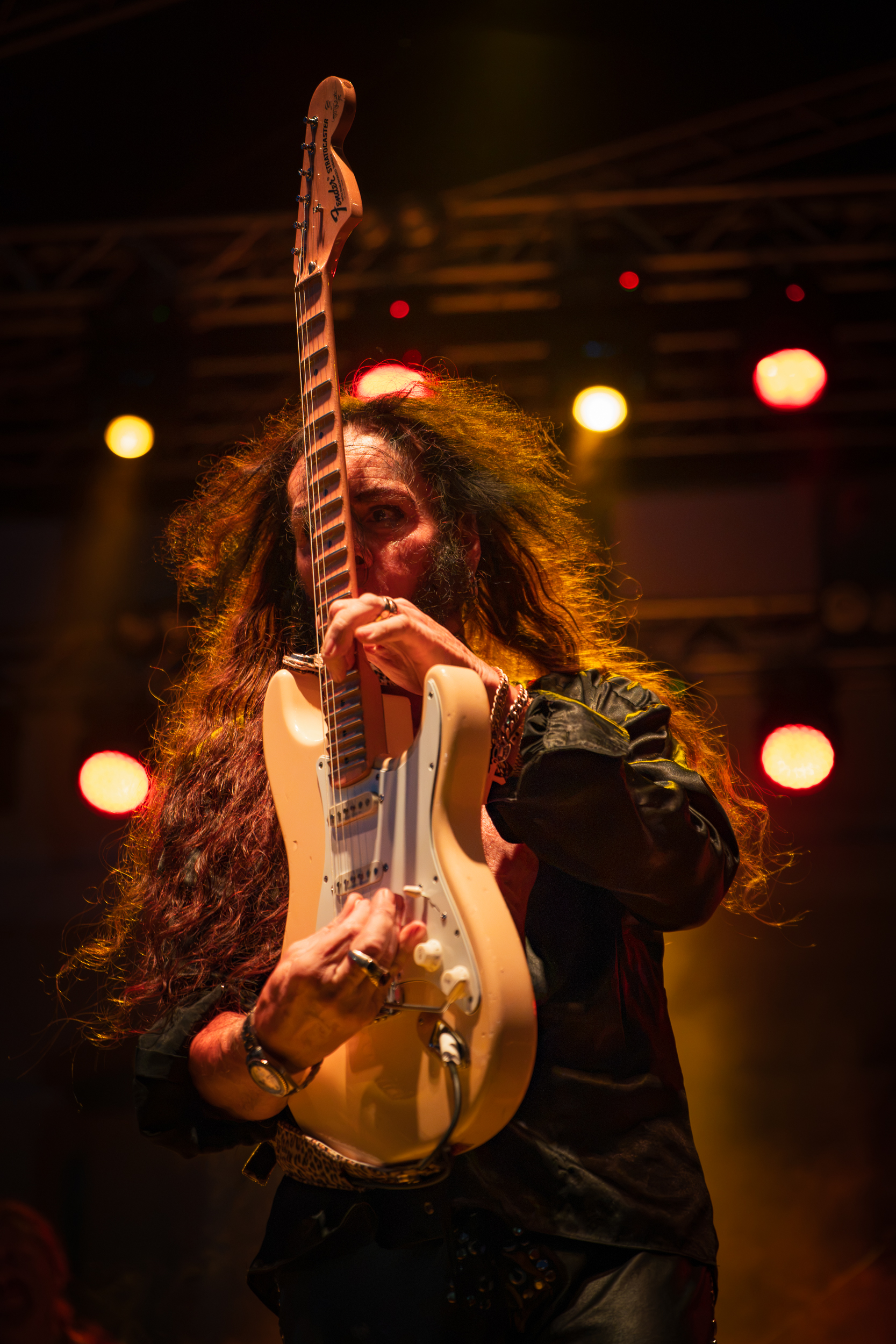 Yngwie Malmsteen holding his Fender Stratocaster vertically in front of his face during his live performance at Moni Lazariston in Thessaloniki