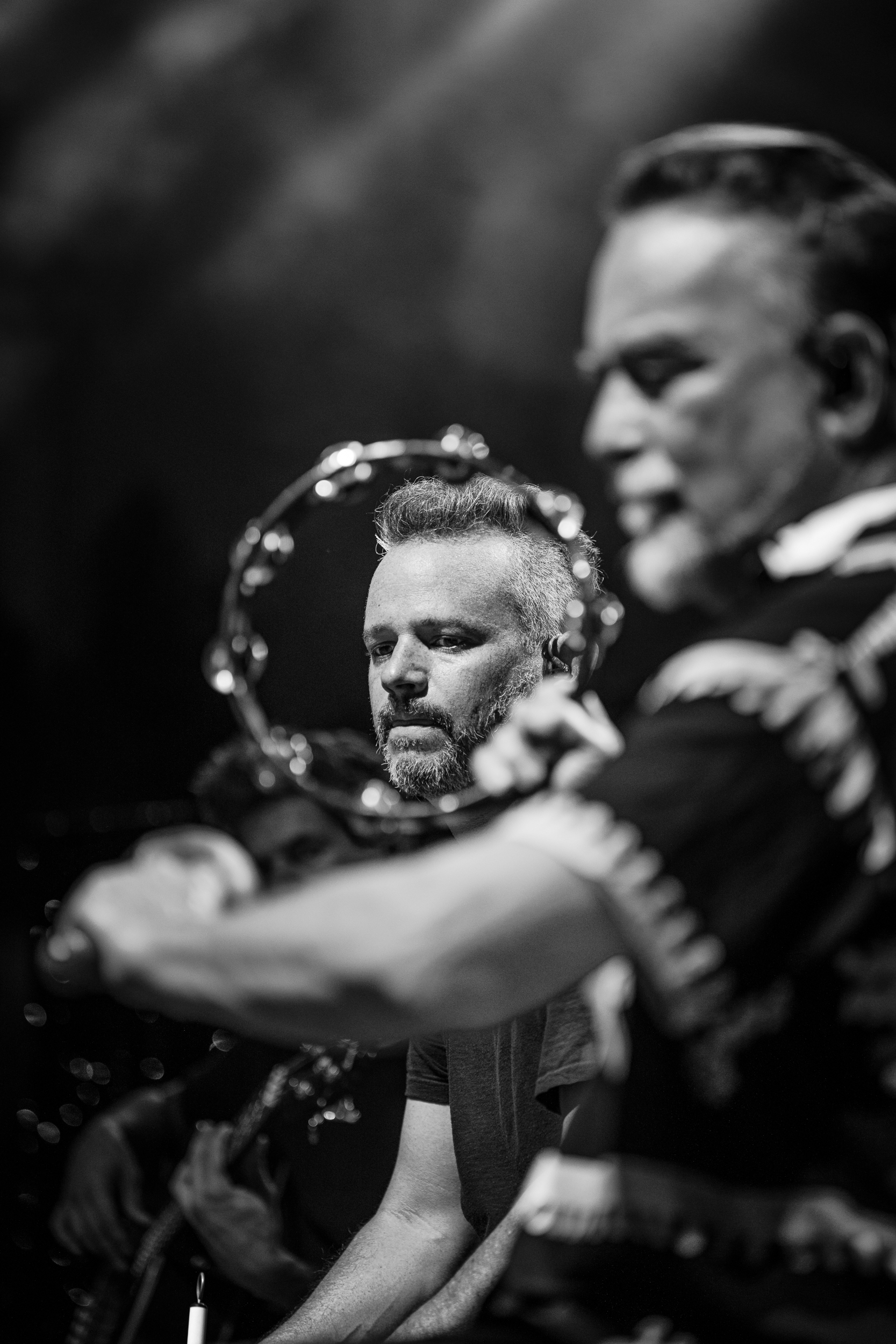 Jeff Franca and Frank Orrall performing during Thievery Corporation’s acoustic section at Moni Lazariston in Thessaloniki, with Frank Orrall holding a tambourine in the foreground.