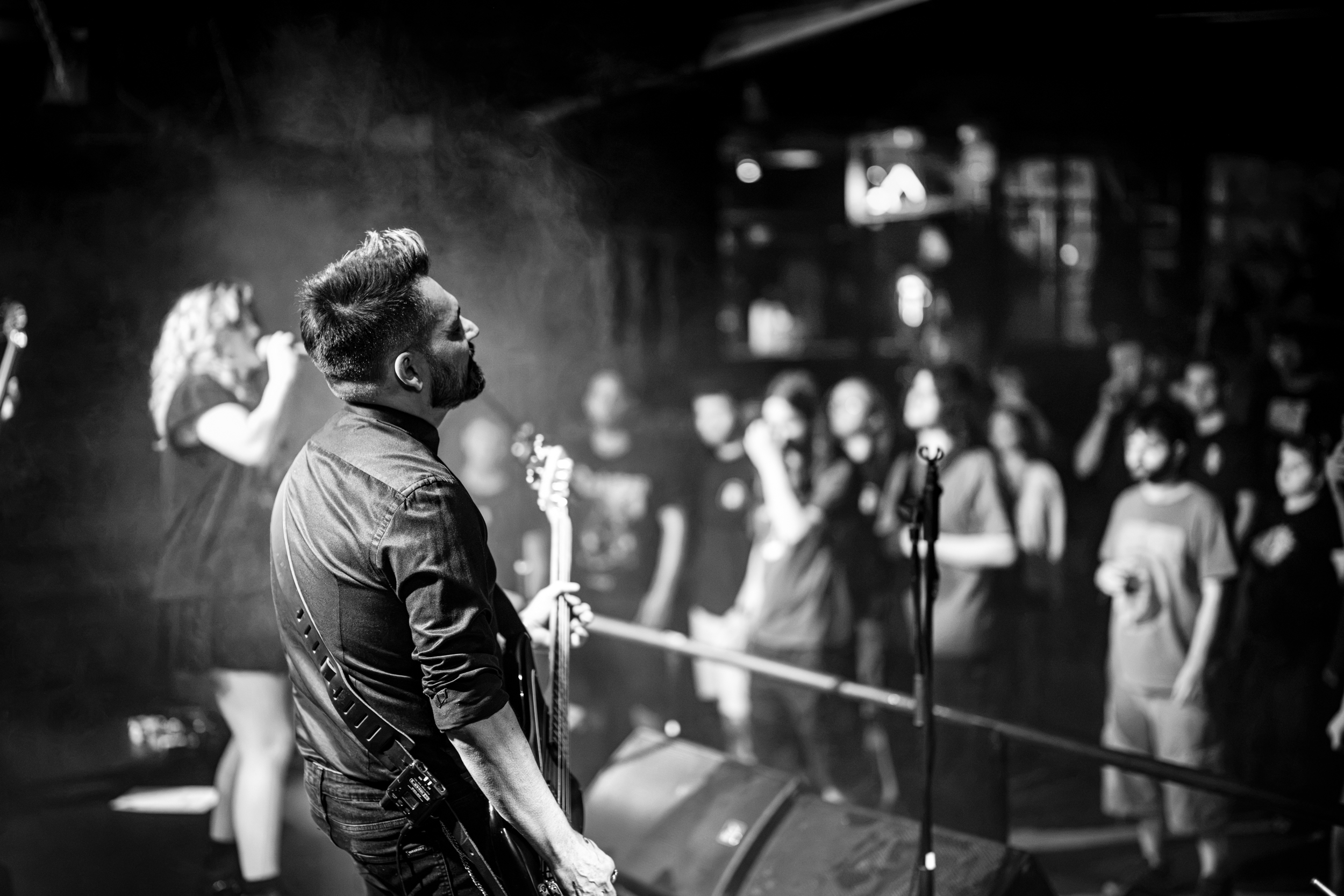 Secular Upheaval performing live at An Club in Athens with bassist and audience visible in the background