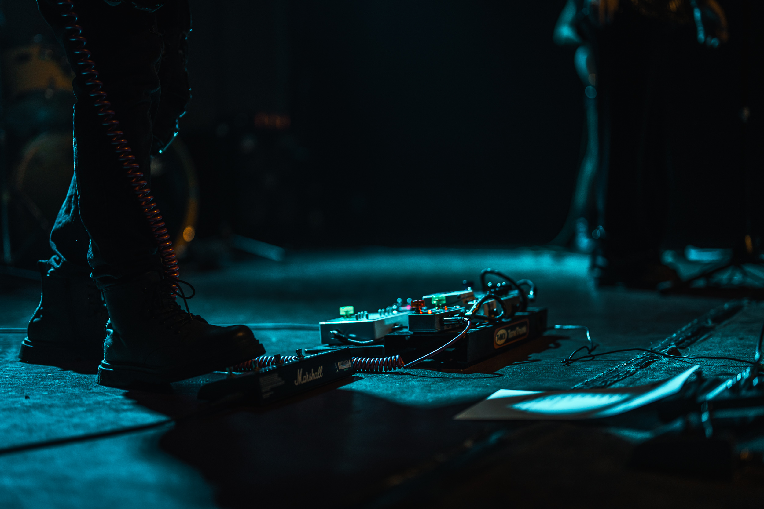 Secular Upheaval guitarist's pedalboard and boots on stage during a live performance at An Club in Athens.